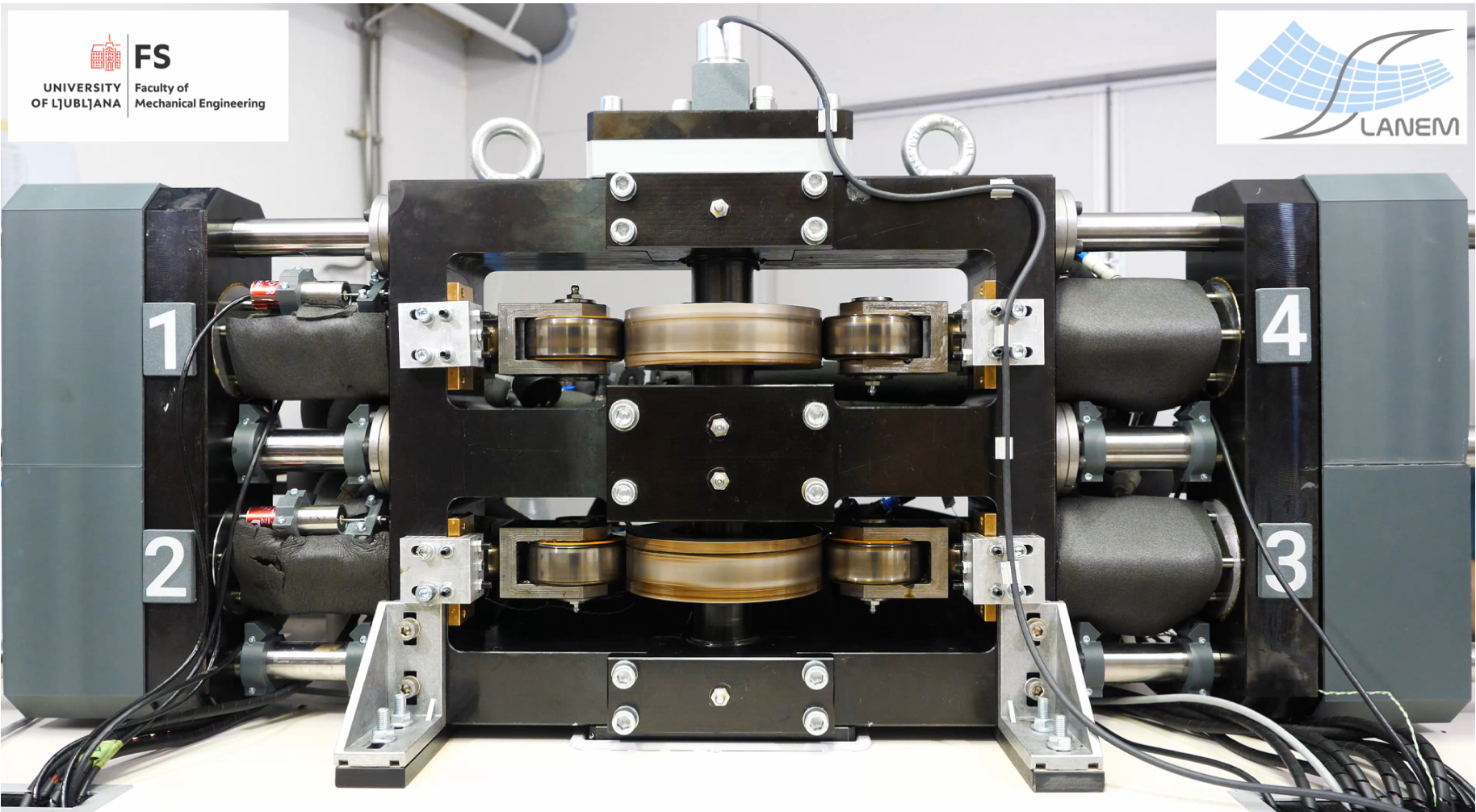 Front view of the integrated TRL 4 elastocaloric prototype, showing the central mechanical drive, supporting frame and four numbered positions.